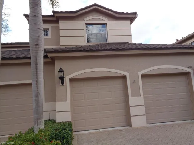 Garage featuring decorative driveway