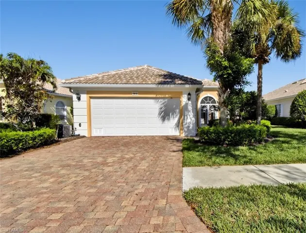 View of front facade featuring an attached garage, driveway, and stucco siding