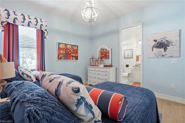 Bedroom with wood finished floors and ensuite bathroom