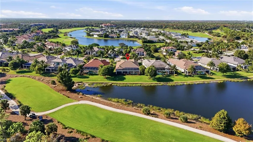 Aerial view of residential area featuring a nearby body of water