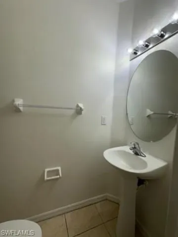 Bathroom featuring light tile patterned floors and toilet