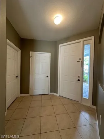 Foyer featuring light tile patterned floors
