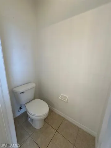 Bathroom featuring baseboards and light tile patterned floors