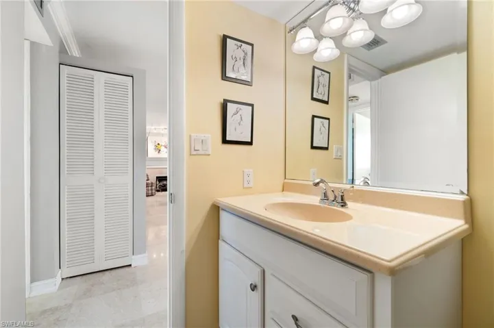 Bathroom featuring vanity, a chandelier, and tile patterned flooring