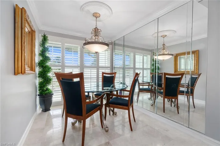 Dining room featuring ornamental molding and baseboards