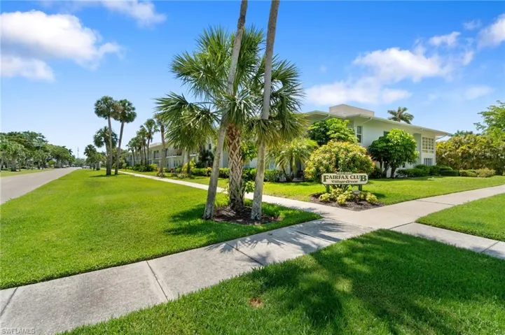 View of property's community with a lawn
