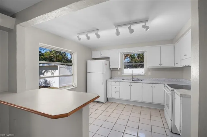Kitchen with light countertops and white cabinets