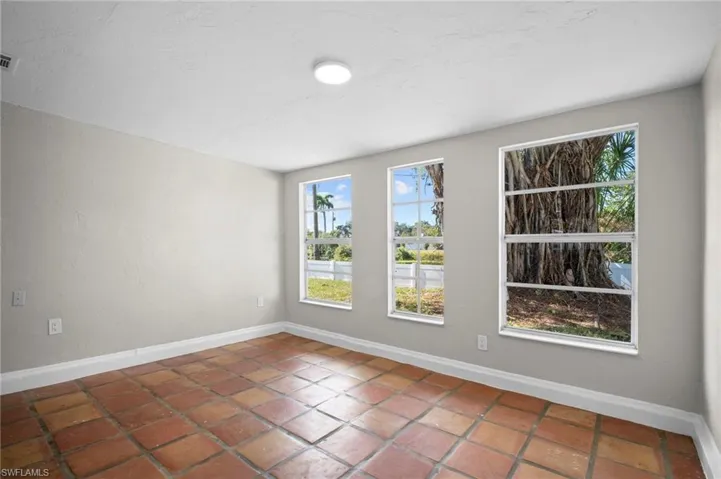 Empty room featuring baseboards