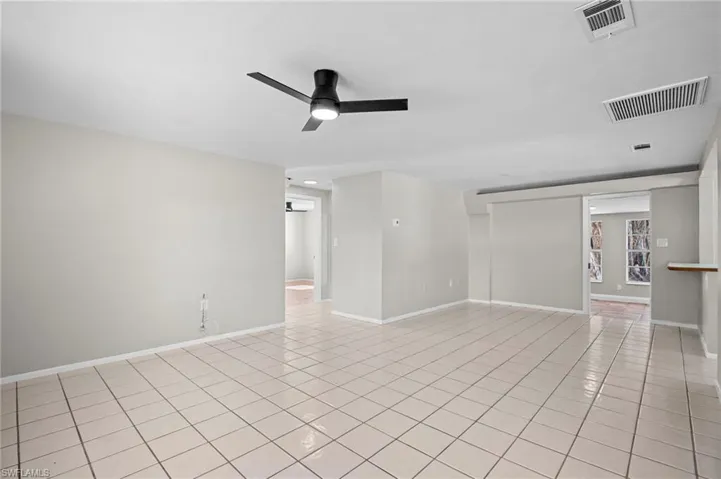 Spare room featuring light tile patterned flooring, a ceiling fan, and recessed lighting