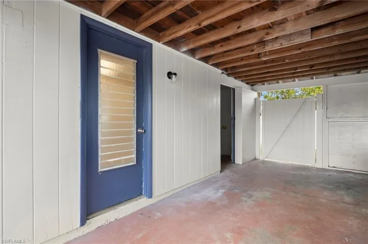 Property entrance with a patio area and a gate