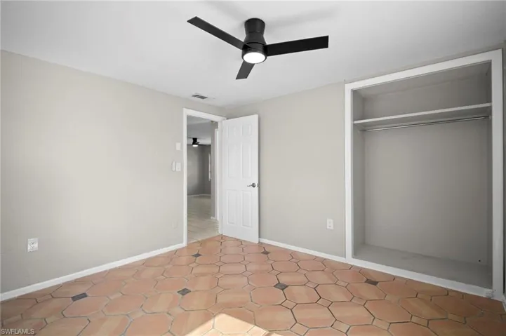 Unfurnished bedroom featuring a closet and ceiling fan