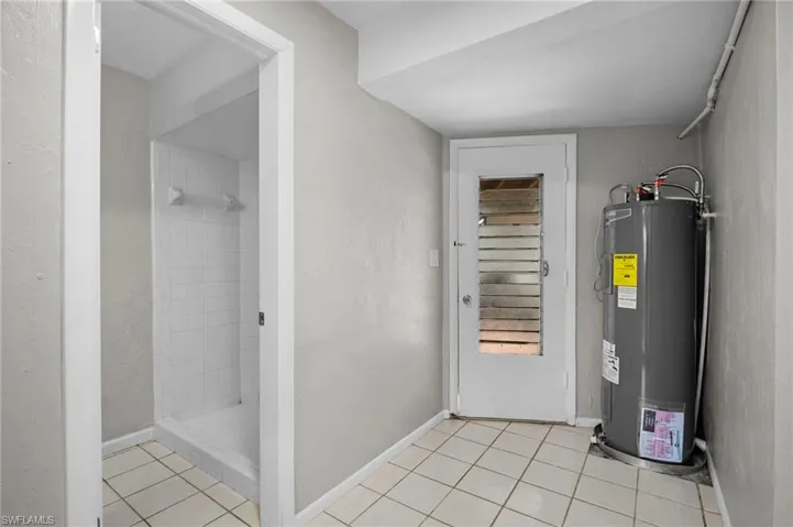 Utility room featuring water heater