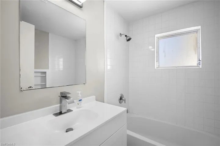 Bathroom with vanity and shower / washtub combination