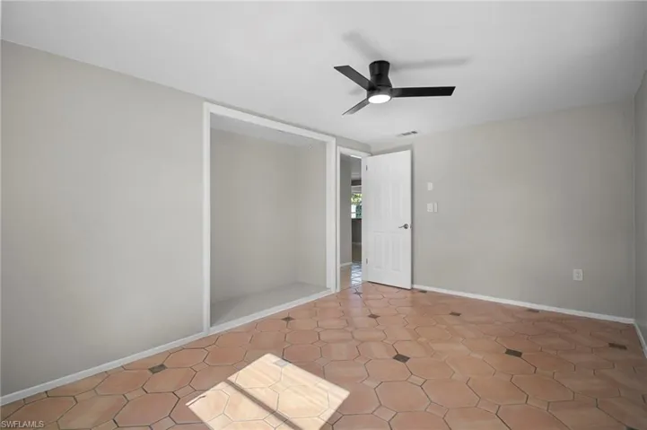 Unfurnished room with baseboards and a ceiling fan