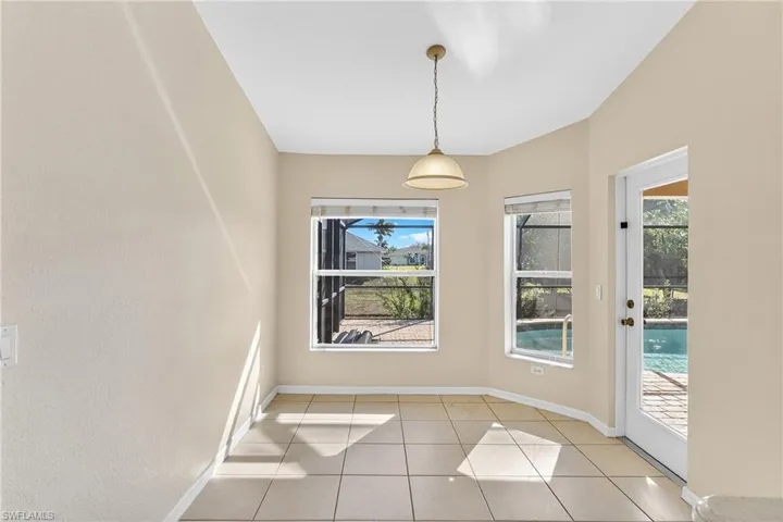 Unfurnished dining area featuring light tile patterned floors and healthy amount of natural light