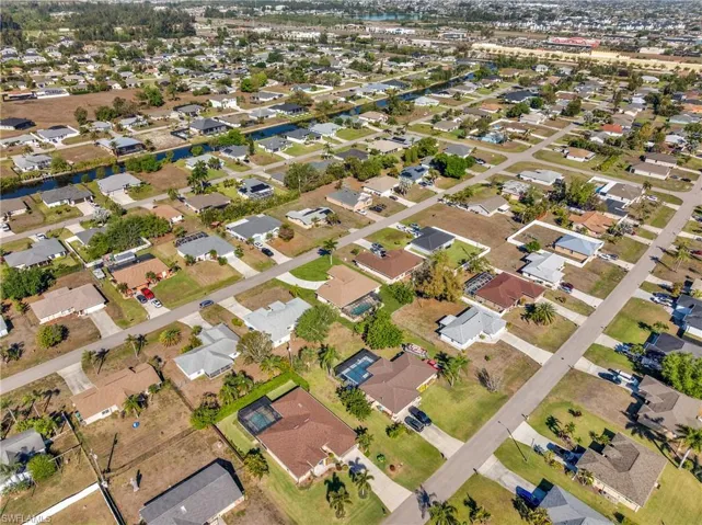 Aerial perspective of suburban area featuring a large body of water