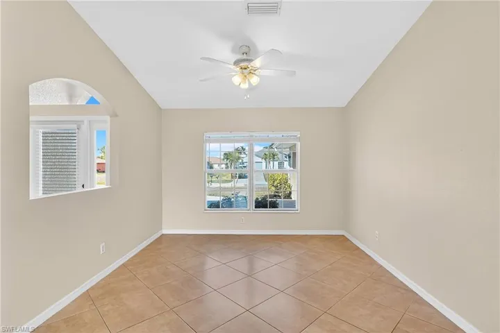 Empty room featuring ceiling fan and light tile patterned flooring