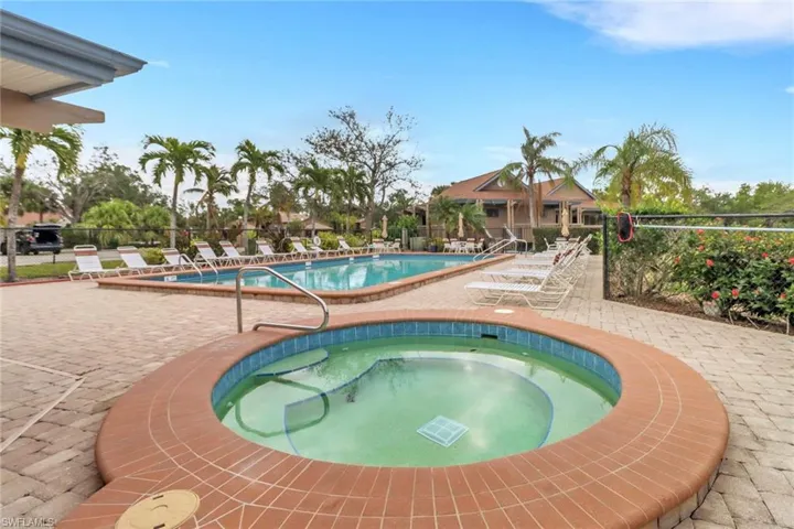 View of swimming pool with a patio area and a community hot tub