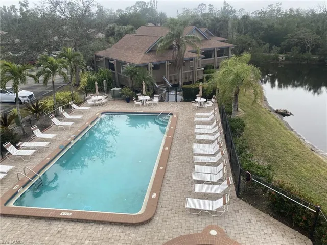 View from the observation deck of the pool, patio area with a water view.