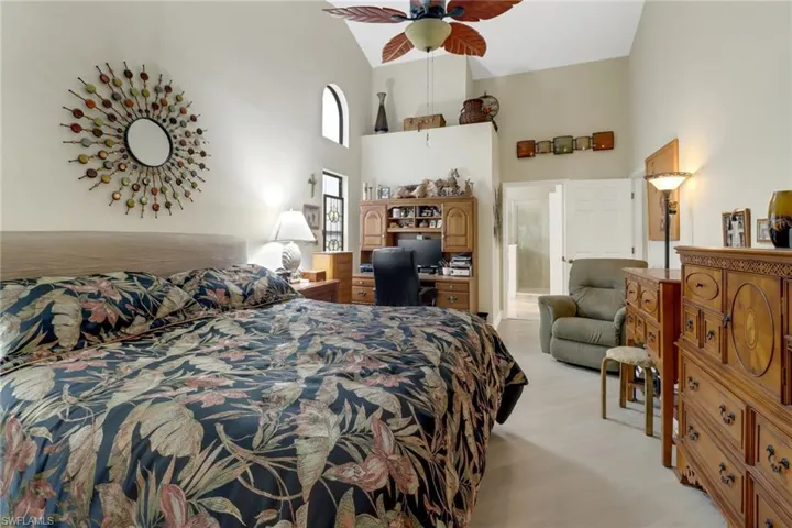 Master Bedroom with high vaulted ceiling, ceiling fan, and connected bathroom