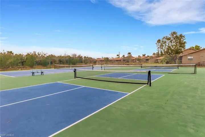View of tennis court featuring basketball court