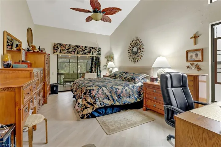 Master Bedroom featuring multiple windows, ceiling fan, light hardwood / wood-style flooring, and vaulted ceiling