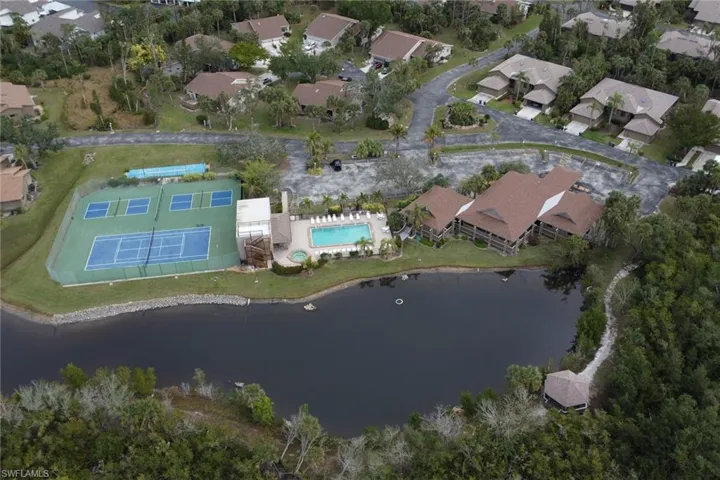 Birds eye view of property with a water view