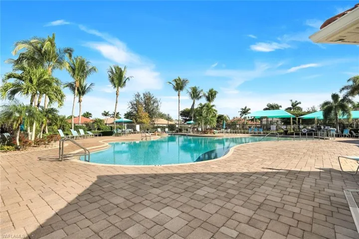 Community pool with a patio