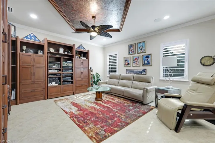 Living room featuring a ceiling fan, light tile patterned floors, recessed lighting, and ornamental molding