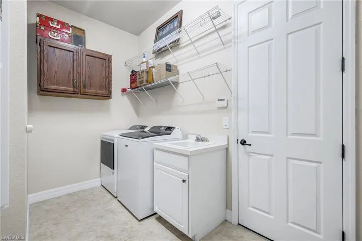 Laundry area featuring cabinet space and washer and clothes dryer