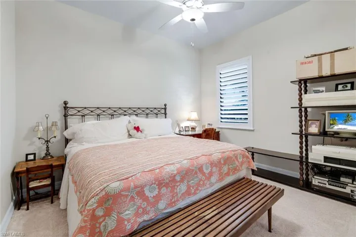 Bedroom with light carpet and a ceiling fan