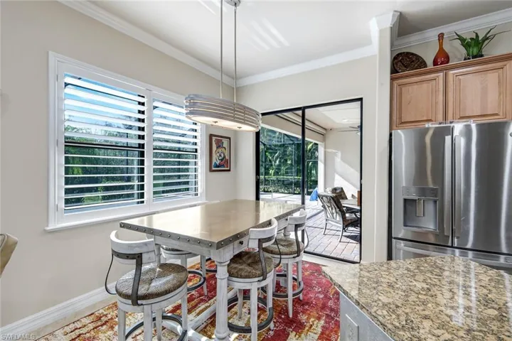 Dining area featuring ornamental molding and baseboards