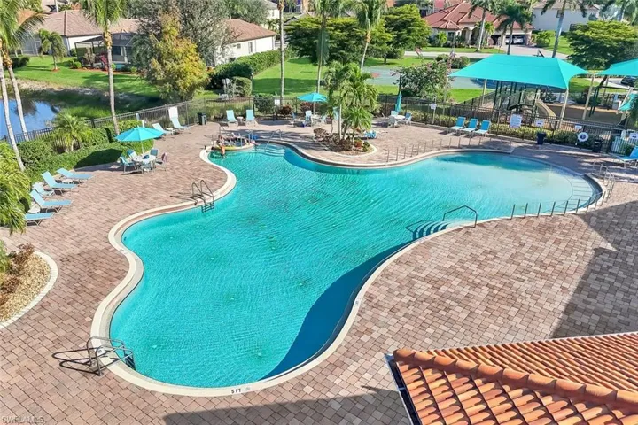 Community pool with a patio