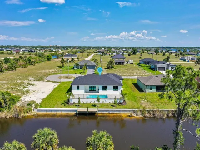 Aerial view featuring a water view and a residential view