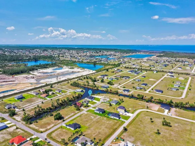 Aerial view featuring a water view and a residential view