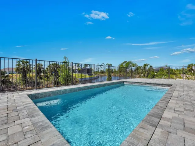 View of swimming pool with fence and a fenced in pool