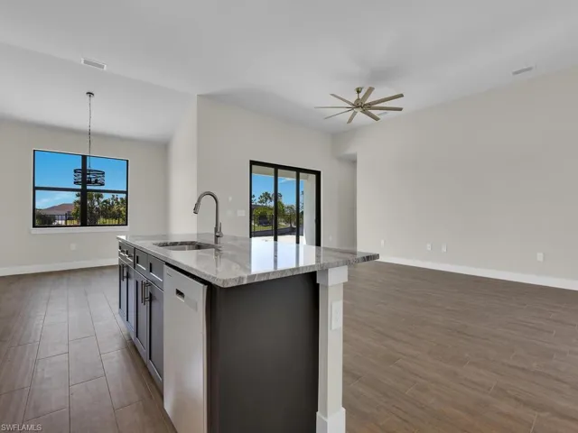 Kitchen with open floor plan, dishwasher, a sink, and a healthy amount of sunlight