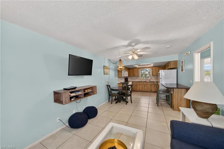Open concept living area featuring light blue walls and tile flooring