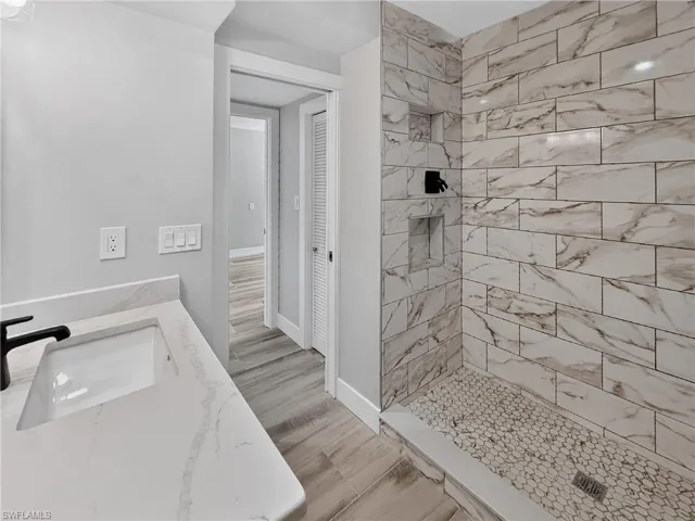 Contemporary bathroom featuring a walk-in shower with large format subway tile walls and a hexagonal mosaic tile floor