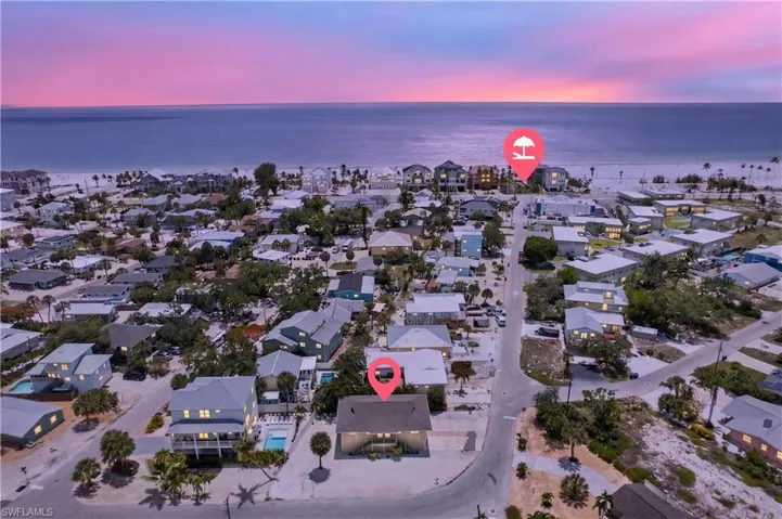 Aerial perspective showcasing a coastal community with an oceanfront backdrop