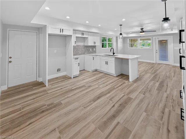 Open-concept living space with wood-finish flooring