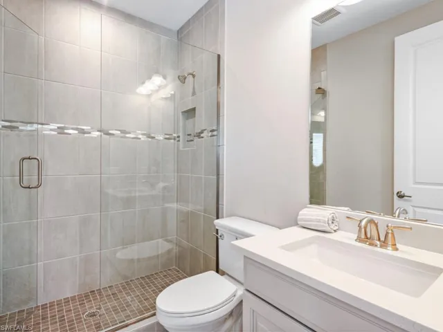 Bathroom featuring vanity and a shower stall
