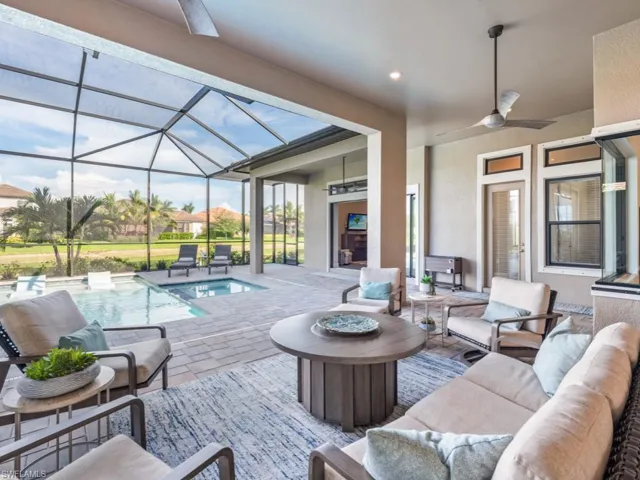 View of patio / terrace featuring ceiling fan, an outdoor hangout area, a sunroom, an outdoor pool, and glass enclosure