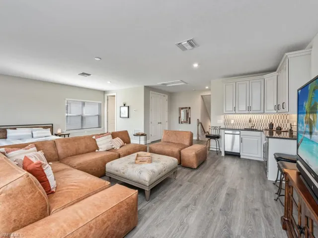 Living room with light wood-style floors and recessed lighting