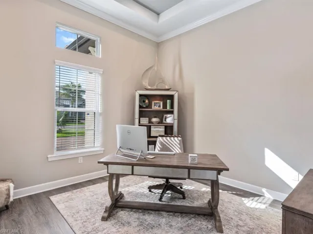 Home office featuring ornamental molding and wood finished floors
