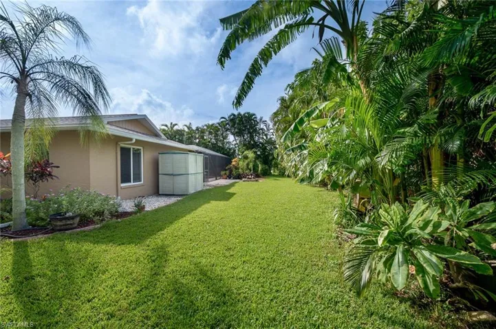 Back yard with lush landscaping.