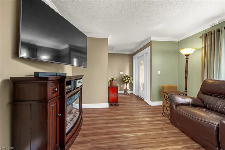 Welcome inside to the living area. Featuring new LVP everywhere but the bedrooms, crown molding and open to the formal dining room.