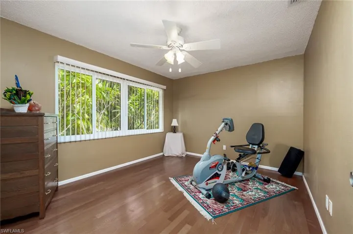 Bedroom with walk in closet currently used as exercise room.