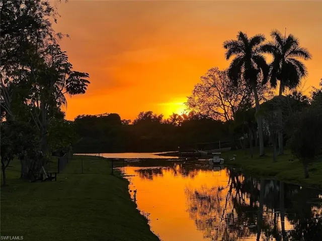 Beautiful Florida Sunset on the canal leading to the lake within the community.