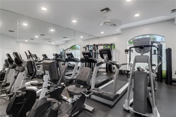 Gym with healthy amount of natural light and recessed lighting